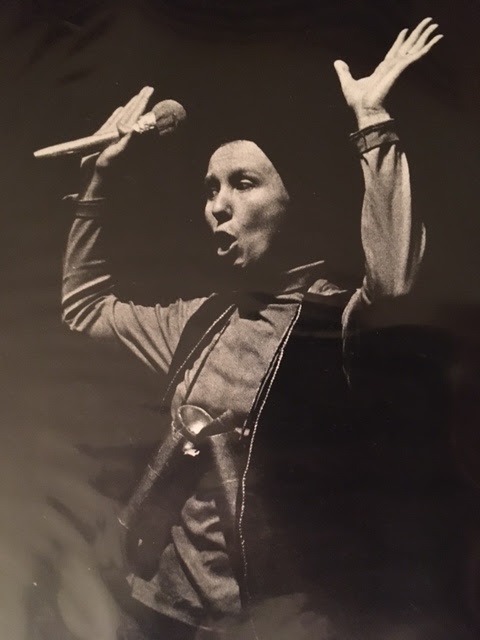 Aili Paal Singer in performance, arms raised